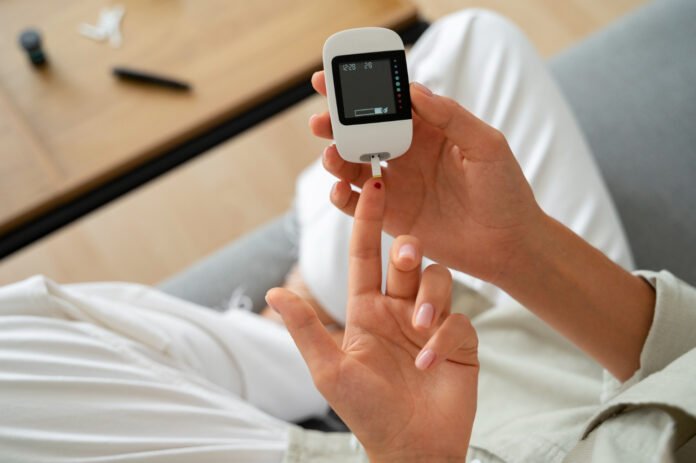 top view diabetic woman checking her glucose level